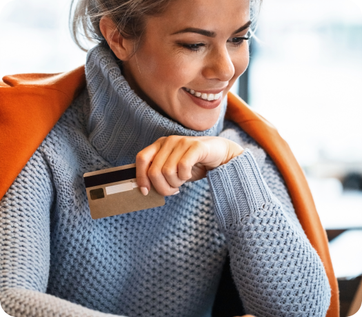 young-happy-businesswoman-using-credit-card-while-surfing-the-net-on-laptop-and-shopping-online 1